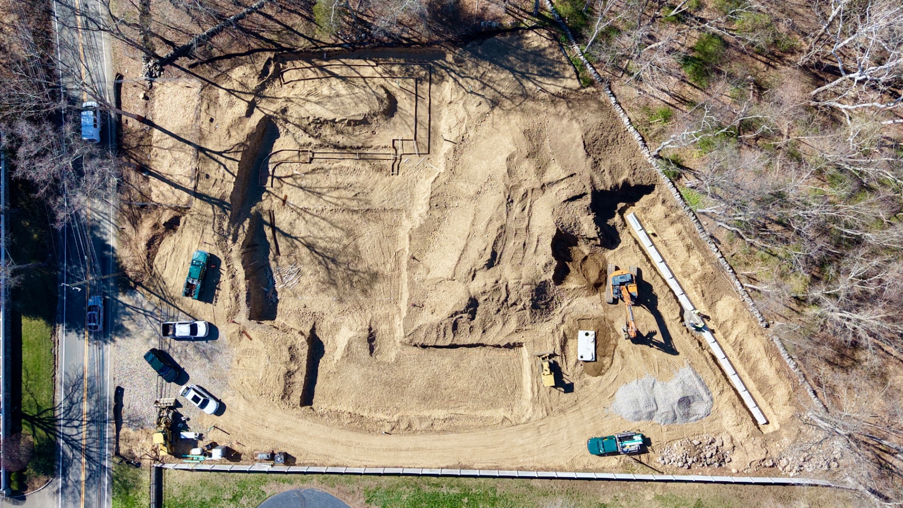 Aerial view of an active dB Architecture construction site — site preparation and foundation work